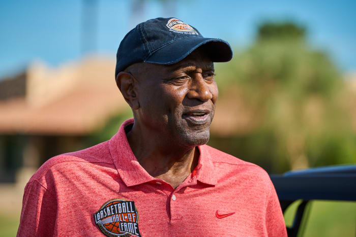 Spencer Haywood speaks on a golf course.
